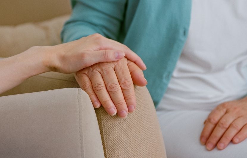 A young woman touching a senior