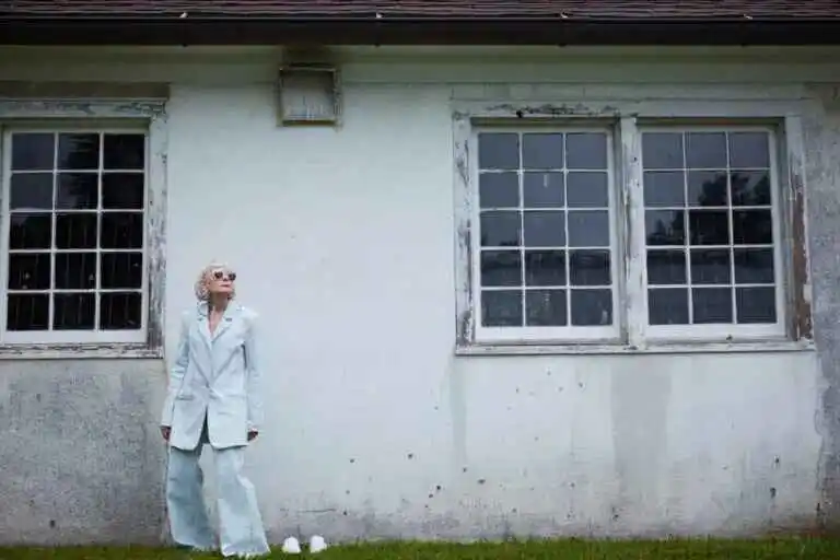 image of Lyn Slater standing by the white wall