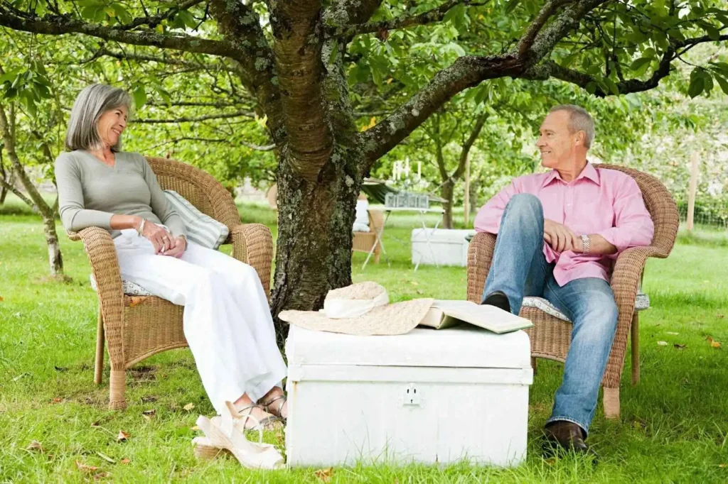 Describing Couple sitting on chairs outdoors  