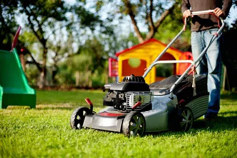Cutting the grass with loan mower