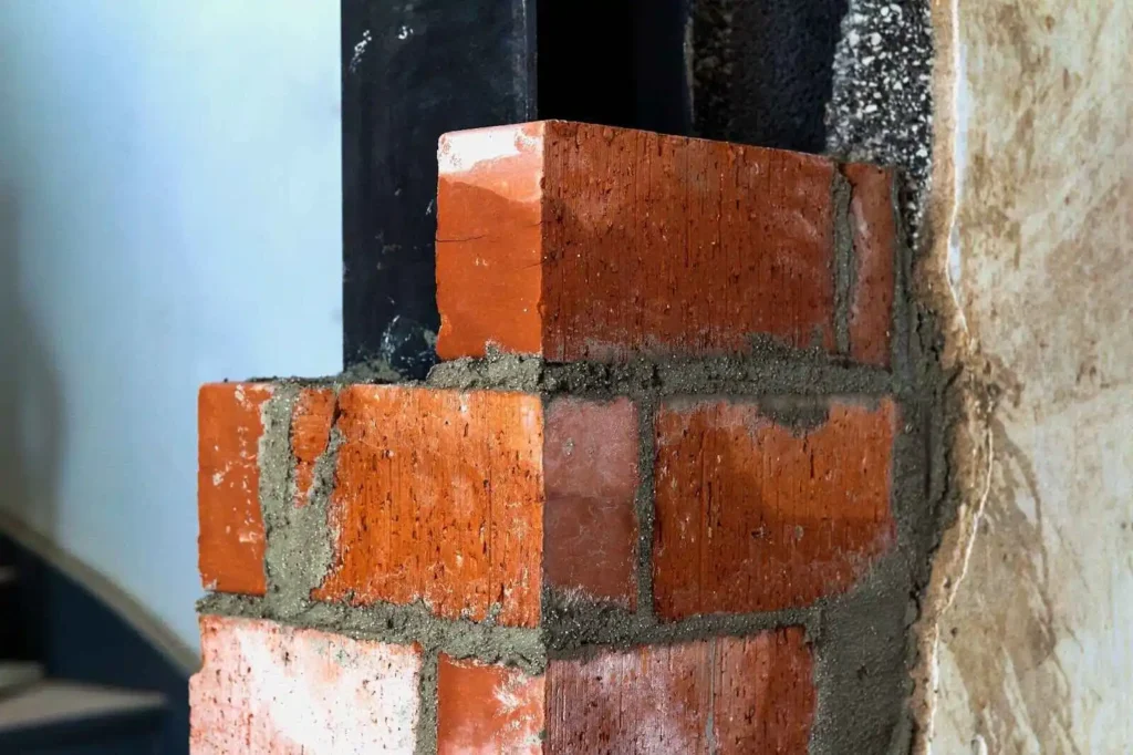 bricklaying on construction site wall