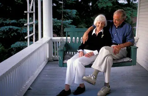 senior couple sitting on deck
