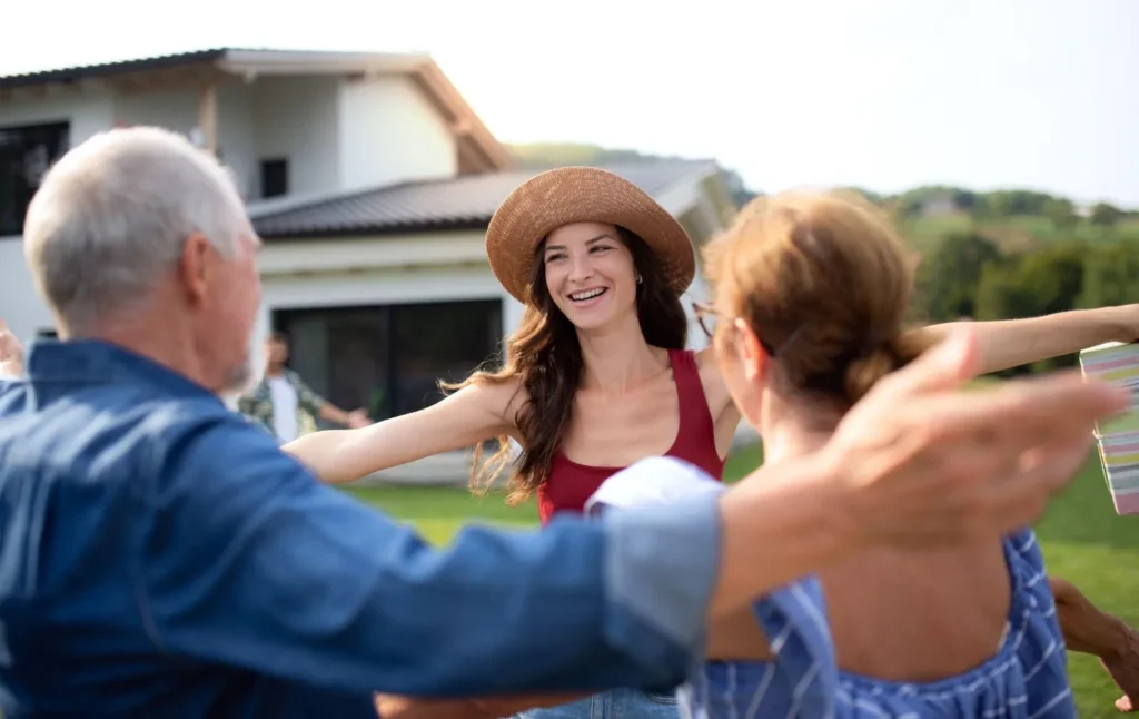 Happy neighbors outdoors on lawn in Ontario