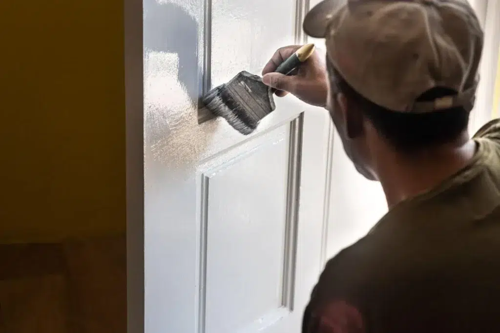 Handyman is Painting white house door