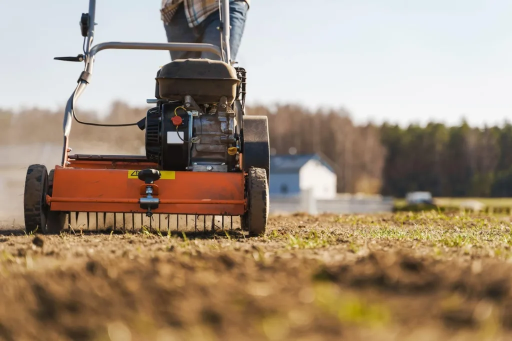 Man using aerator machine to scarification